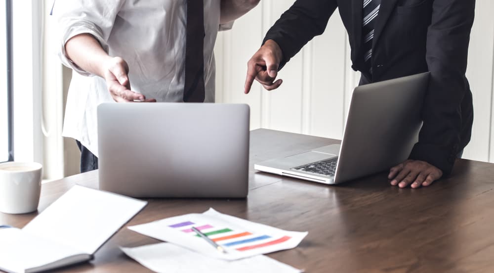 Two business partners argue intensely in office, highlighting how partnership disputes can quickly turn bitter.