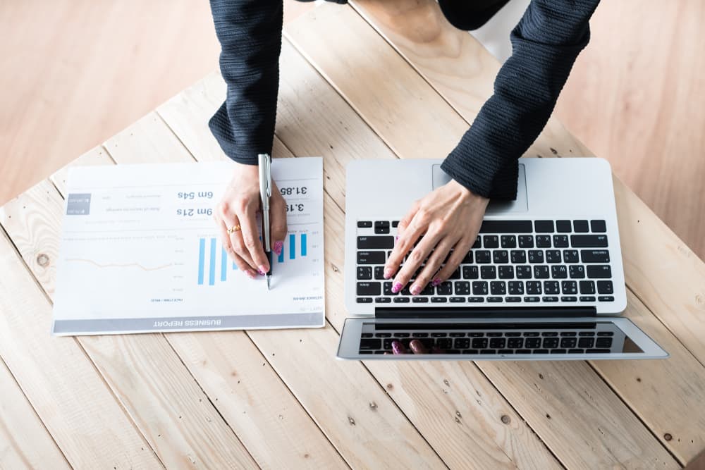 Business women reviewing data in financial charts and graphs