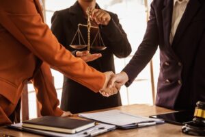 Lawyers shaking hands, providing legal guidance, court representation, and handling legal paperwork to protect clients' rights and ensure justice.