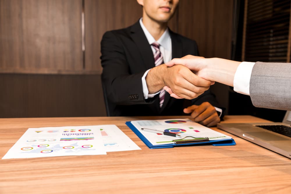 businessman and businesswoman shaking hands.