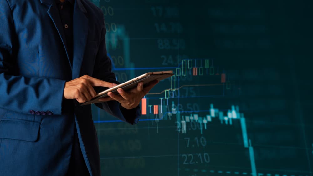 Businessman finger touching tablet with finance and banking profit graph of stock market trade indicator financial,