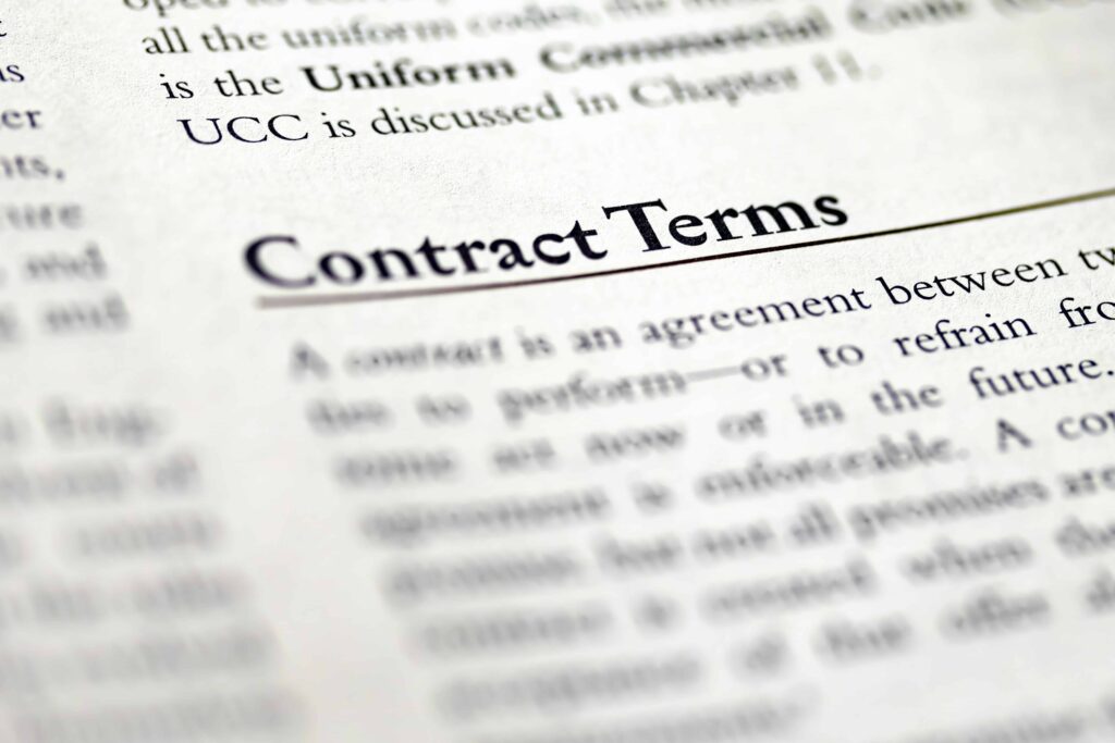 Close-up of a legal document showing the section titled &lsquo;Contract Terms&rsquo; defining agreement conditions.