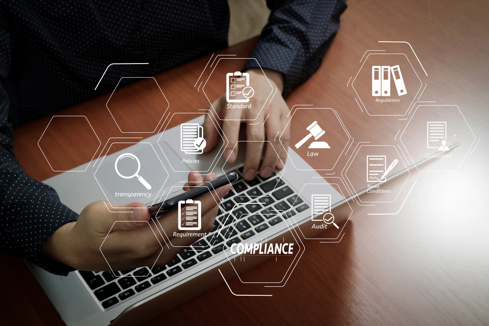 Business man using smart phone and laptop to verify information